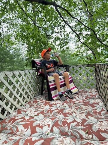 Brody's chillin' up in his treehouse he helped me  build over the weekend... good job dude